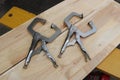 Vise grip locking clamp on wooden background