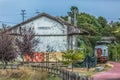 View of a abandoned train station, building and older rustic train, wagon with graffiti street art