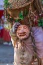 View of farmer doll, manipulated with people inside, carrying large traditional basket, at the Medieval market of Canas