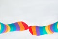 Visibility of LGBTQ+ community. Two left feet wearing socks with rainbow flag. White background Royalty Free Stock Photo