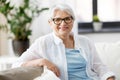 Portrait of happy senior woman in glasses at home