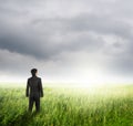 Vision business man in fields and rainclouds Royalty Free Stock Photo