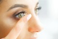 Vision Contact Lenses. Closeup With Beautiful Woman Face