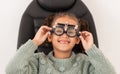 Vision, eye exam and girl with trial lens for prescription spectacles at optometry shop. Eyewear, eyesight test and