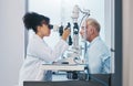 Vision, eye test and insurance with a doctor woman or optometrist testing the eyes of a man patient in a clinic Royalty Free Stock Photo