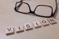 Vision: Wooden block letters and a pair of glasses