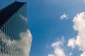 Modern skyscraper with reflections of clouds on windows Royalty Free Stock Photo