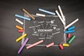 Visionary. Illustration with icons, keywords and direction arrows on dark chalkboard background Royalty Free Stock Photo
