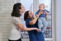 Visit of doctor pediatrician home, mother with baby son talking with doctor