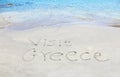 Visit greece written on sand Royalty Free Stock Photo