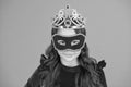 Visit public event anonymously. Winter new year party. Winter carnival. Incognito mode. Girl wear mask and crown orange Royalty Free Stock Photo