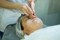 A visit to a beautician. Doctor beautician prepares the patient`s face for the procedure - carboxytherapy. The preparatory stage