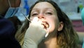 Visit to the dentist, correction of malocclusion, treatment teeth. Orthodontist checks the installed braces in the