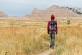 Girl Walking Down Gravel Path into Mountains of Badland National Park