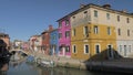 Visiting Burano island in Italy Scene with canal and traditional colored homes