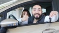 Visiting car dealership. Beautiful family is talking and smiling while sitting in their new car . young man shows finger Royalty Free Stock Photo