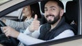 Visiting car dealership. Beautiful family is talking and smiling while sitting in their new car . young man shows finger Royalty Free Stock Photo