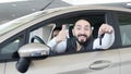 Visiting car dealership. Beautiful family is talking and smiling while sitting in their new car . young man shows finger Royalty Free Stock Photo