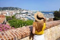 Visiting French Riviera. Back view of pretty girl enjoying ciyscape of Cannes, France