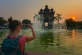 Visiting Laos - Young Woman admires beautiful Patuxai Monument in the city of Vientiane Royalty Free Stock Photo