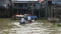 Visiting others in a raft in a broken boat in Floating Village in Tonle Sap Lake Cambodia Royalty Free Stock Photo