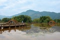 Visitor and Beautiful mountain woods and wooden bridge and it`s reflection in lake Royalty Free Stock Photo