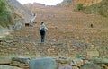 Visitor Climbing onto the Terraces of Pumatallis Inside Ollantaytambo Incas Citadel, Urubamba Province, Peru