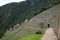 Visitor exploring the aechaeological site of Machu Picchu in the early morning, Cusco region, Peru