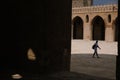 Visitor inside the Mosque of Ibn Tulun, Cairo, Egypt with blue sky with shadows Royalty Free Stock Photo