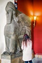 Visitor looking on Assyrian Lamassu or winged bull in Pergamon museum in city Berlin at Germany