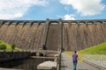 A visitor looking at one of the dams in the summertime of the Elan valley of Wales. Royalty Free Stock Photo
