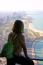 A visitors looking out of the former Hancock Tower in Chicago, Illinois