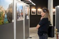 Visitor looking at works in an art gallery.