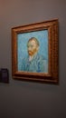 Visitor near the Self-Portrait by Vincent van Gogh painting in Museum d'Orsay in Paris, France. Royalty Free Stock Photo