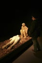 Visitor observing human victim body cast