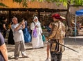 A visitor photographs a child with a participant dressed as a Spanish grandee at the Knights of Jerusalem Festival at the Ein Yael