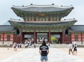 A visitor standing in front of Gyeongbokgung Palace