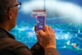 Visitor taking pictures with his mobile phone at MWC19 in Barcelona