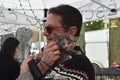 Visitor interacts with rescue kitten from Nashville Cat Rescue at Oktoberfest Event