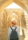 Visitor Walking Along the Iconic Archways of Qal`at al-Bahrain Fort, Manama, Bahrain Royalty Free Stock Photo