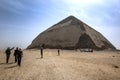 Visitors approach the Bent Pyramid at Dahshur in Egypt.
