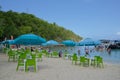 Visitors, Boats, and Tables With Umbrellas at Honeymoon Beach on Water Island