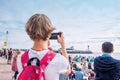 Visitors of Bournemouth Air Festival 2018 making video on the phone. Red Arrows - Royal Air Force air plaines under Bournemouth be Royalty Free Stock Photo