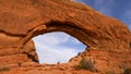 Visitors climbing the arch at Arches National Park - UTAH, USA - MARCH 20, 2019