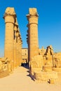 Visitors come along the Colonnade of Amenhotep III in the Luxor Temple in Egypt