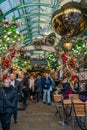 Visitors in Covent Garden`s popular Apple Market decorated for Christmas Royalty Free Stock Photo