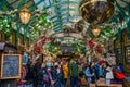 Visitors in Covent Garden`s popular Apple Market decorated for Christmas Royalty Free Stock Photo