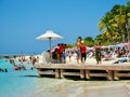 Visitors Enjoying the White Sandy Beach and Clear Blue Water at Montego Bay Beach, Jamaica Royalty Free Stock Photo