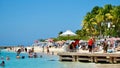 Visitors Enjoying the White Sandy Beach and Clear Blue Water at Montego Bay Beach, Jamaica Royalty Free Stock Photo