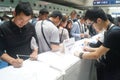 Visitors fill out personal information into the exhibition hall Royalty Free Stock Photo